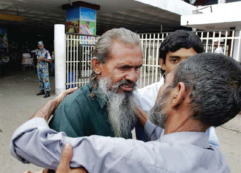 DHAKA, Bangladesh: In this file photo, Bangladeshi man Moslemuddin Sarkar, 52, center, who had been missing since 1989 is hugged by his brother Sekandar Ali, right, after he arrived at the airport in Dhaka, Bangladesh. — AP