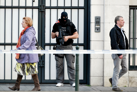 BRUSSELS: A policeman stand guards the Brussels courthouse yesterday. Mohammed Abrini, suspected bomber Osama Krayem and two other suspects have been heard yesterday at the Brussels courthouse. — AFP