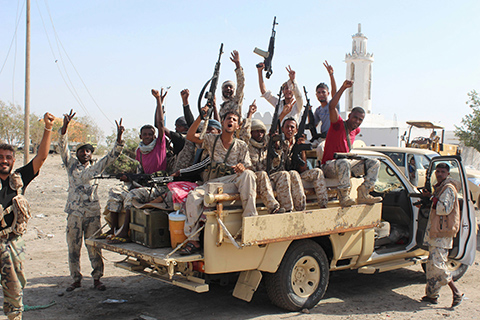 ABYAN, Yemen: Forces loyal to the Saudi-backed Yemeni president brandish their arms at the entrance to this province as they take part in an operation to drive Al-Qaeda fighters out of the southern provincial capital yesterday. - AFP