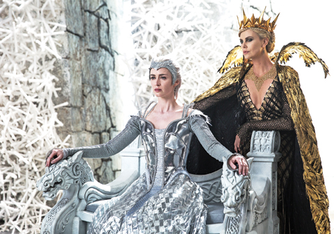 In this image released by Universal Pictures, Emily Blunt, left, and Charlize Theron appear in a scene from ‘Huntsman: Winter’s War.’—AP
