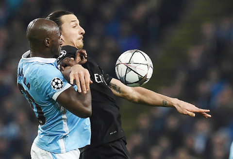 MANCHESTER: Paris Saint-Germain's Swedish forward Zlatan Ibrahimovic (R) vies with Manchester City's French defender Eliaquim Mangala during the UEFA Champions league quarter-final second leg football match between Manchester City and Paris Saint-Germain at the Etihad stadium in Manchester yesterday. -- AFP n