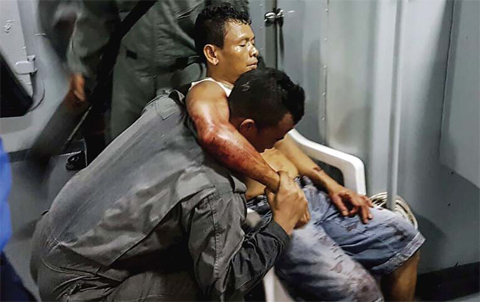 LAHAD DATU: Malaysian Maritime Enforcement Agency shows a member of Malaysian Maritime Enforcement Force rescuing an Indonesian sailor after being shot during a kidnapping at the east coast of Malaysia’s Sabah state in Lahad Datu. — AFP