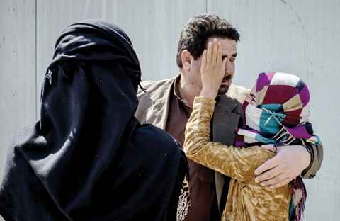 MAKHMOUR, Iraq: In this March 31, 2016 photo, Yumana, 13, wipes tears from the face of her father, Sheikh Matar, after being separated from him for over a year. — AP