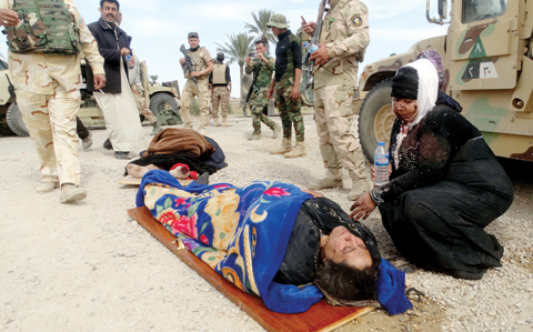 RAMADI: An injured woman comforts another as they wait for treatment after clashes between Iraqi Security forces and Islamic State group extremists. — AP