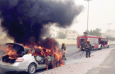 KUWAIT: Flames are seen coming out of a vehicle at Fourth Ring Road yesterday.