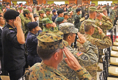 MANILA: Philippine and US soldiers, along with visiting military attache members, salute as the national anthems of both the US and Philippines are played during the opening ceremony of the annual joint 11-day Balikatan (Shoulder-to-Shoulder) military exercise yesterday. — AFP