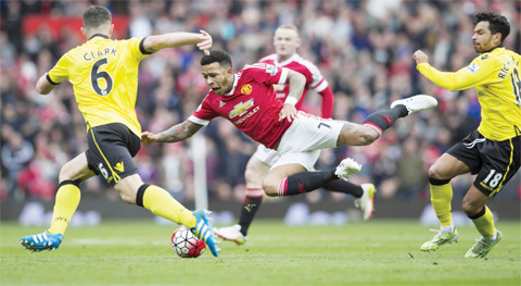 MANCHESTER: Manchester United’s Memphis Depay, centre, is brought down by Aston Villa’s Kieran Richardson, right, earning Richardson a booking as Ciaran Clark looks on during the English Premier League soccer match between Manchester United and Aston Villa at Old Trafford Stadium, Manchester, England, yesterday. — AP