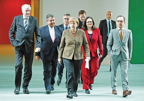 BERLIN: (L-R) Bavarian state premier and leader of the conservative Christian Social Union (CSU) Horst Seehofer, German Vice Chancellor, Economy and Energy Minister Sigmar Gabriel, German Interior Minister Thomas de Maiziere, German Chancellor Angela Merkel, German Labor and Social Minister Andrea Nahles, German Justice Minister Heiko Maas arrive for a press conference yesterday at the Chancellery in Berlin. — AFP