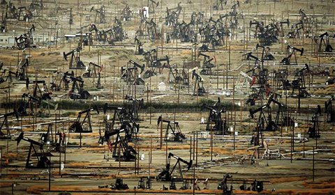 BAKERSFIELD: Oil pumping jacks and drilling pads at the Kern River Oil Field where the principle operator is the Chevron Corporation in Bakersfield, California. US energy firm Chevron reported yesterday a loss of $725 million in the first quarter, joining the growing list of petroleum giants that finished the period in the red. — AFP