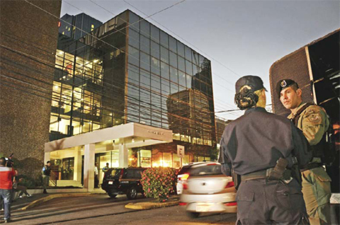 PANAMA CITY: Police stand guard outside the Mossack Fonseca law firm offices during a raid on Tuesday. — AFP