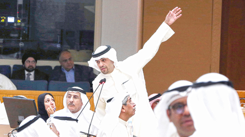 KUWAIT: Finance Minister and acting oil minister Anas Al-Saleh gestures as Electricity and Water Minister Ahmad Al-Jassar looks on during a parliament session at the National Assembly yesterday. - Photo by Yasser Al-Zayyat