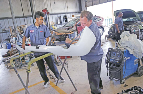 NEW ORLEANS: Tony Kirsch, right, an auto body technician, works with Montrel Stiebling, a former inmate at the Louisiana State Penitentiary in Angola, and graduate of their work release training program, in the body shop of Toyota. — AP