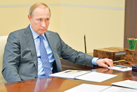 MOSCOW: Russian President Vladimir Putin listens during a meeting in the Novo-Ogaryov residence on Monday.-AP