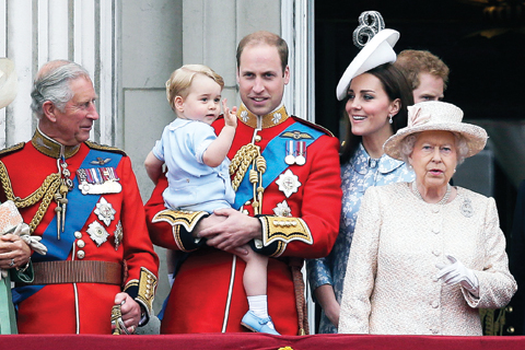 In this Saturday, June 13, 2015 file photo, Britain’s Prince William holds his son Prince George, with Queen Elizabeth II, right, Kate, Duchess of Cambridge and the Prince of Wales during the Trooping The Color parade at Buckingham Palace in London