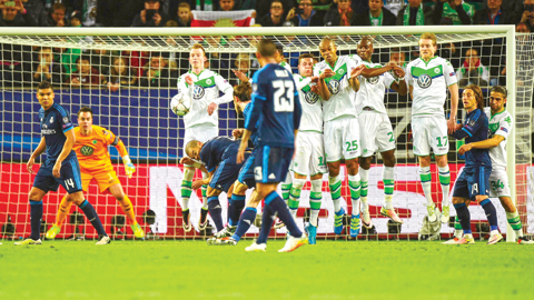 WOLFSBURG: Wolfsburg's midfielder Maximilian Arnold (3rdL) and teammates defend against a free kick during the UEFA Champions League quarter-final, first-leg football match between VfL Wolfsburg and Real Madrid yesterday in Wolfsburg, northern Germany.  -- AFP 