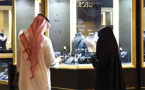 RIYADH: A Saudi couple looks at jewelry during the Riyadh international Jewelry exhibition in the Saudi capital Riyadh. — AFP