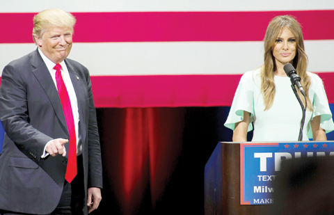 MILWAUKEE: Republican presidential candidate Donald Trump listens to his wife Melania Trump speak to supporters at a campaign stop on Monday. — AFP