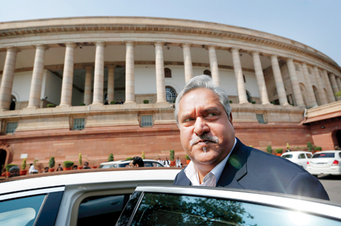 NEW DELHI: Indian business tycoon and owner of Kingfisher Airlines Vijay Mallya gets into his car outside the Parliament on Feb. 27, 2013. — AP