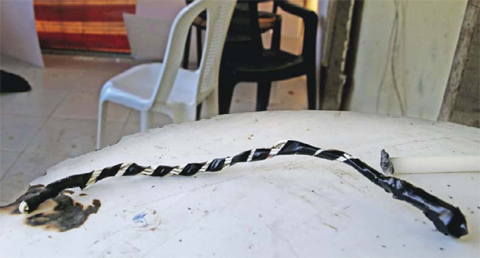 MAAMELTEINE, LEBANON: This picture taken on Thursday shows a whip that remains on the table of the guard’s room of the Chez Maurice Hotel. — AP