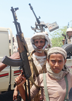 Forces loyal to the Saudi-backed Yemeni president flash their arms on a road on the entrance to Abyan province as they take part in an operation to drive Al-Qaeda fighters out of the southern provincial capital. — AFP