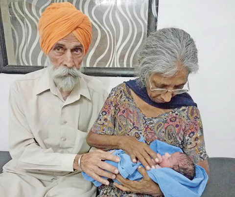 HISSAR: Indian couple Mohinder Singh Gill (left) poses with his wife Daljinder Kaur and their newly born baby at The National Fertility Centre in Hissar. — AFP