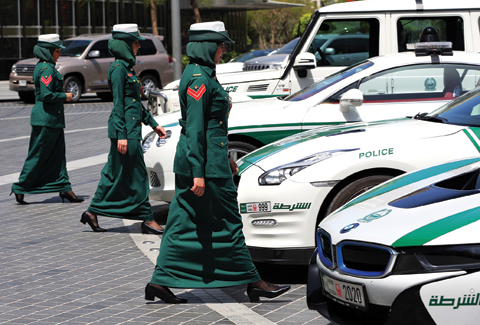 Dubai police women walk towards their luxury cars during a demonstration in Dubai, United Arab Emirates. — AP photos
