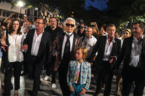 Fashion designer Karl Lagerfeld, center, attends the presentation of his ‘cruise’ line for fashion house Chanel, at the Paseo del Prado street in Havana, Cuba