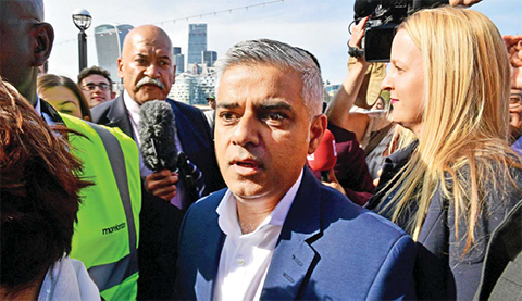 LONDON: Britain’s Labor party candidate for London Mayor Sadiq Khan (C) arrives at City Hall in central Londonnyesterday. —AFP