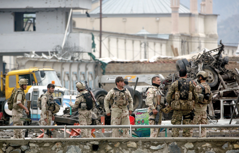KABUL: Afghan security forces inspect the site of a Taleban-claimed deadly suicide attack. — AP
