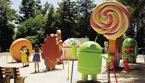 MOUNTAIN VIEW, CALIFORNIA: People pose by Android lawn statues at Google’s headquarters. — AP