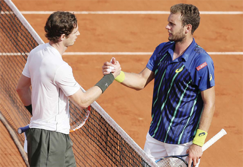 PARIS: Britain’s Andy Murray, left, shakes hands with France’s Mathias Bourgue after their second round match of the French Open tennis tournament at the Roland Garros stadium. — AP