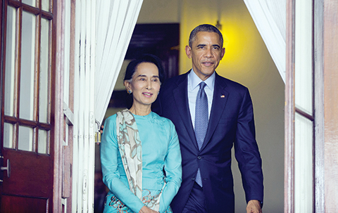 FILE - In this Nov. 14, 2014 file photo, Aung San Suu Kyi, walks with President Barack Obama for their joint news conference at her home in Yangon, Myanmar. The U.S. business lobby says it is high time to drop the remaining U.S. sanctions on Myanmar, but human rights activists and U.S. lawmakers say not so fast. That poses a dilemma for President Barack Obama, who next week is expected to renew sanctions for another year but take some state-run companies off a Treasury blacklist. (AP Photo/Pablo Martinez Monsivais, File)