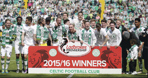 GLASGOW: Celtic players celebrate winning the Scottish Premiership League after the match against Aberdeen at Celtic Park. — AP