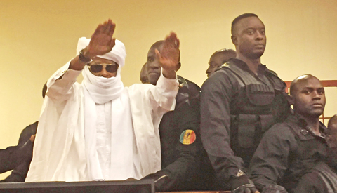 DAKAR: Chad’s former dictator Hissene Habre raises his hands after his sentencing during court proceedings yesterday. — AP