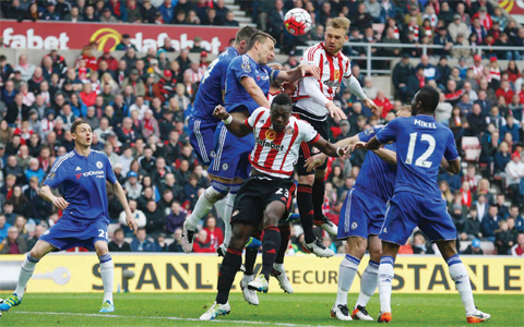 SUNDERLAND: Sunderland’s German defender Jan Kirchhoff (centre right) climbs to head the ball as Chelsea’s English defender John Terry (3rd left) defends during the English Premier League football match between Sunderland and Chelsea yesterday.—AFP