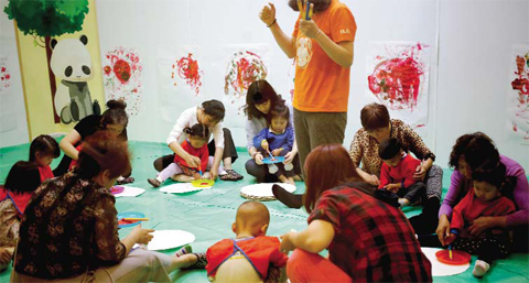 CHINA: Children accompanied by their parents and caretakers, attend an art class at the I Love Gym center in Beijing. — AP photos