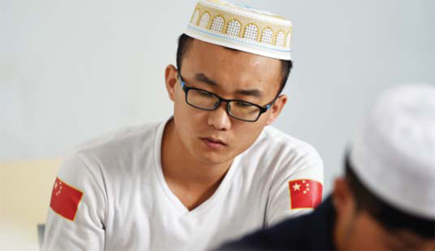 YINCHUAN, CHINA: A Chinese Hui Muslim student attending a class at the Ningxia Islamic Institute. —AFP