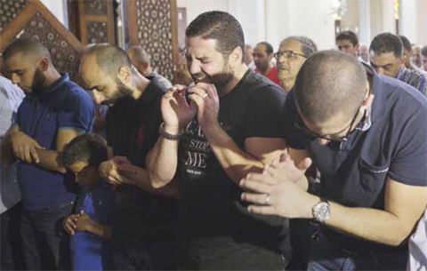 CAIRO: Egyptian film director Osman Abu Laban (center) who lost four relatives, all victims of Thursday’s EgyptAir plane crash, attends prayers for the dead, at Al-Thawrah Mosque, in Cairo, yesterday. — AP