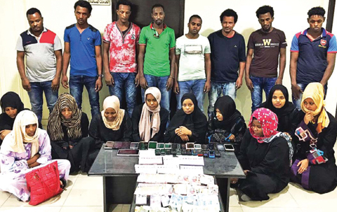 KUWAIT: This handout photo shows members of a gang arrested yesterday for running a fake domestic help office