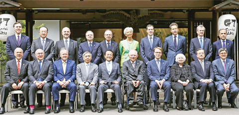 AKIU, Japan: Japanese Finance Minister Taro Aso (fifth from left in front row) poses with other finance ministers and heads of central banks of the Group of Seven for a group photo in Akiu, northern Japan, yesterday. — AP