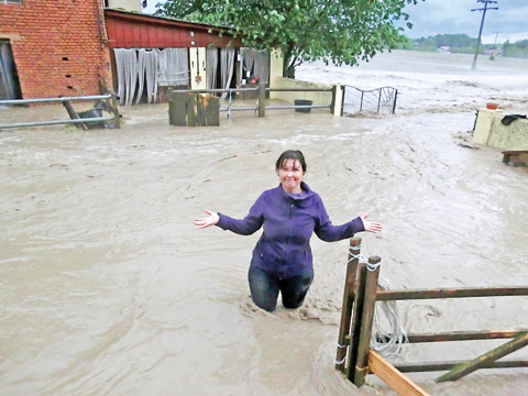 OBERNZENN: A woman stands amidst the water flooding a horse farm in Obernzenn, southern Germany. — AFP