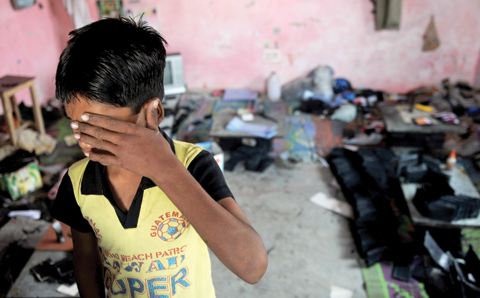 NEW DELHI: File photo shows an Indian bonded child laborer crying during a raid and rescue operation conducted by the Bachpan Bachao Andolan (Save the Childhood Movement) in New Delhi. — AFP
