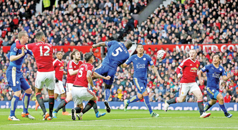 MANCHESTER: Leicester City’s Wes Morgan (centre) scores his side’s first goal of the game during the English Premier League match against Manchester United at Old Trafford yesterday. — AP