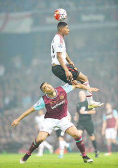 LONDON: Manchester United’s English striker Marcus Rashford (top) vies with West Ham United’s New Zealand defender Winston Reid during the English Premier League football match between West Ham United and Manchester United on May 10, 2016. — AFP