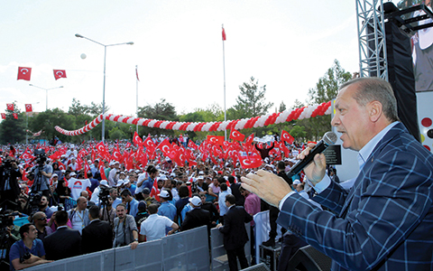 Turkey's President Recep Tayyip Erdogan addresses a rally in the mainly Kurdish city of Diyarbakir, Turkey, Saturday, May 28, 2016.  Erdogan pressed ahead with his criticism of the United States over the U.S. troops' wearing the patches of Syrian Kurdish forces, despite U.S. assurances.  (Kayhan Ozer, Presidential Press Service/Pool via AP)