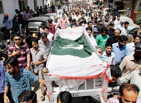 KARACHI, PAKISTAN: Mourners carry the coffin of slain activist Khurram Zaki for a funeral yesterday. — AP