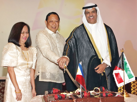 KUWAIT: Philippine Ambassador to Kuwait Renato Pedro Villa and Kuwait’s Deputy Foreign Minister for Asian Affairs Ambassador Ali Al-Saeed cut the ceremonial cake