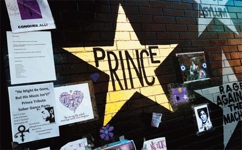 MINNEAPOLIS: A star honoring Prince, now painted gold, stands out on the wall, Thursday at a memorial for the singer at First Avenue, a venue where he often performed. — AP