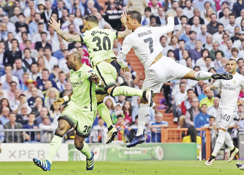 MADRID: Real Madrid’s Portuguese forward Cristiano Ronaldo (right) vies with Manchester City’s Argentinean defender Nicolas Otamendi (center) and Manchester City’s French defender Eliaquim Mangala during the UEFA Champions League semi-final second leg football match at the Santiago Bernabeu stadium yesterday. — AFP