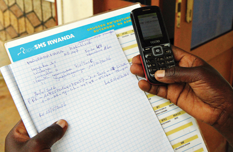 NYARUKOMBE, Rwanda: A pregnant woman records her information by SMS on the country’s “RapidSMS” health system on April 27, 2016. — AFP